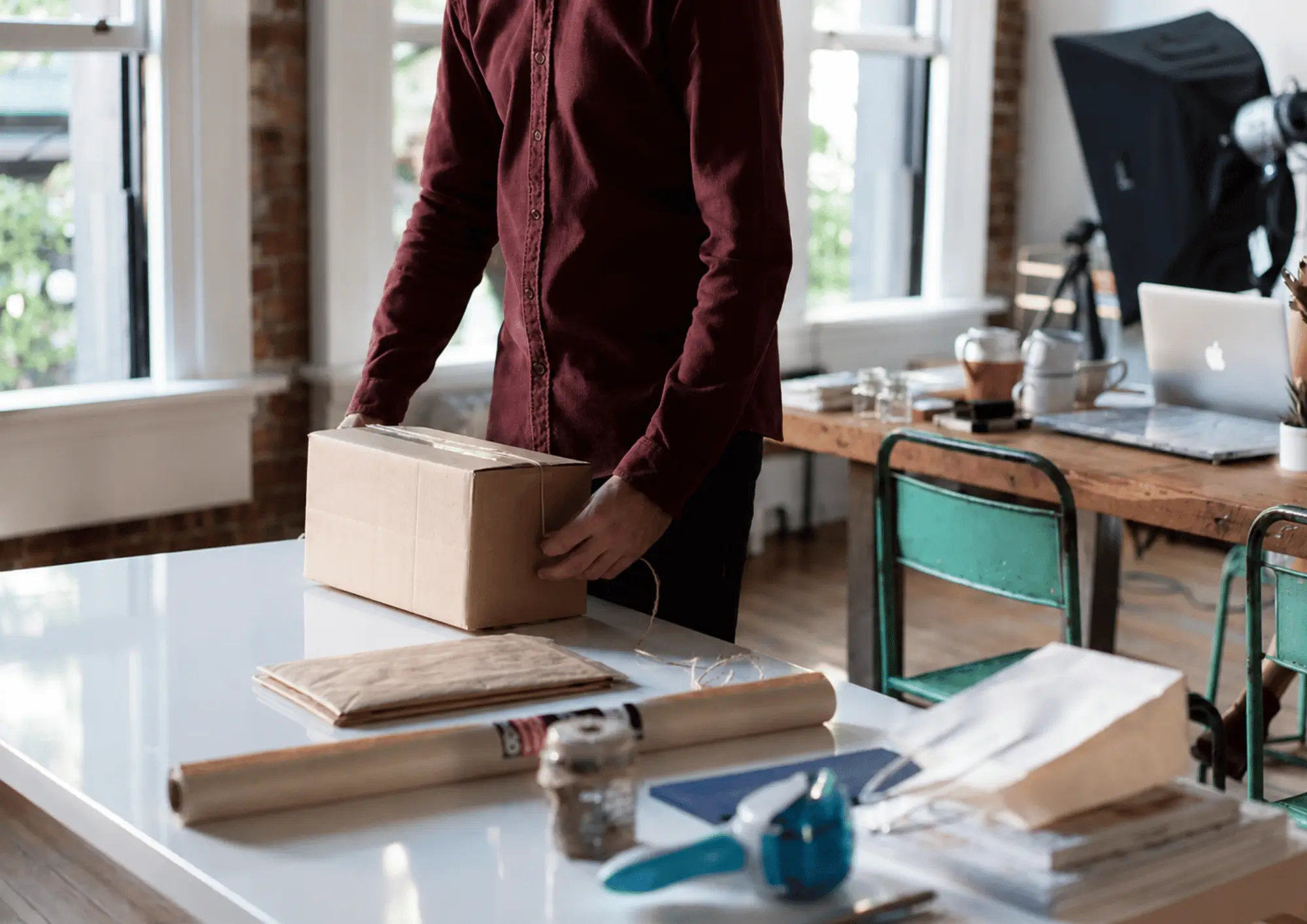 Small business owner packing an e-commerce order for shipping